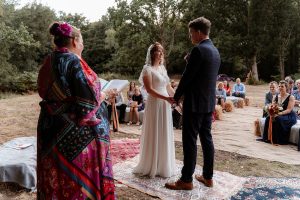Outdoor wedding ceremony with guests present.