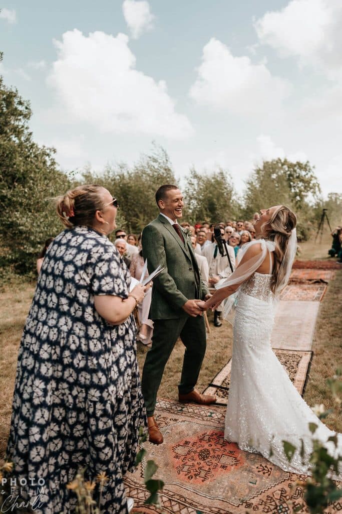 wedding couple at their ceremony in an orchard