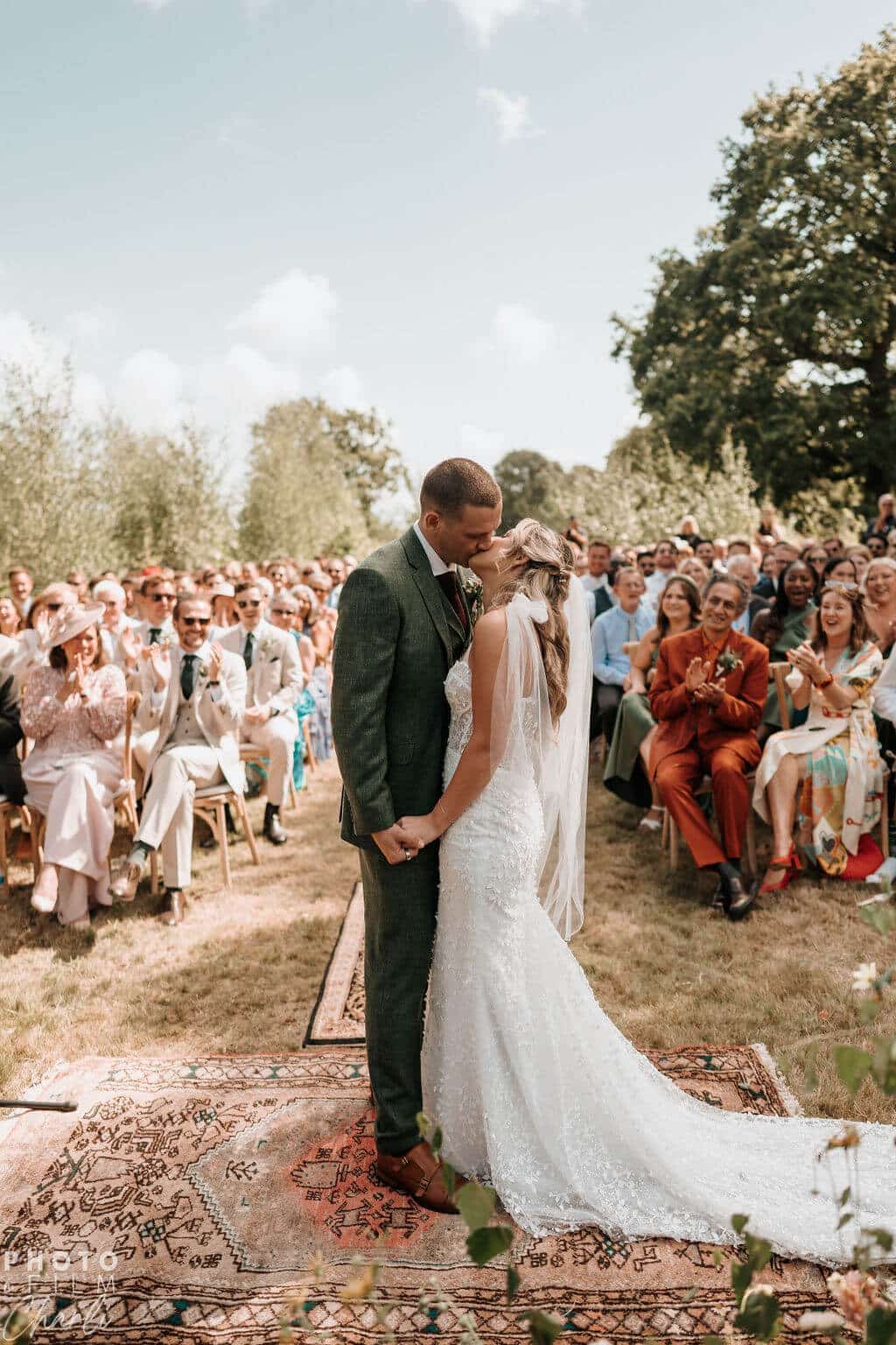 Couple exchanging vows at outdoor wedding.