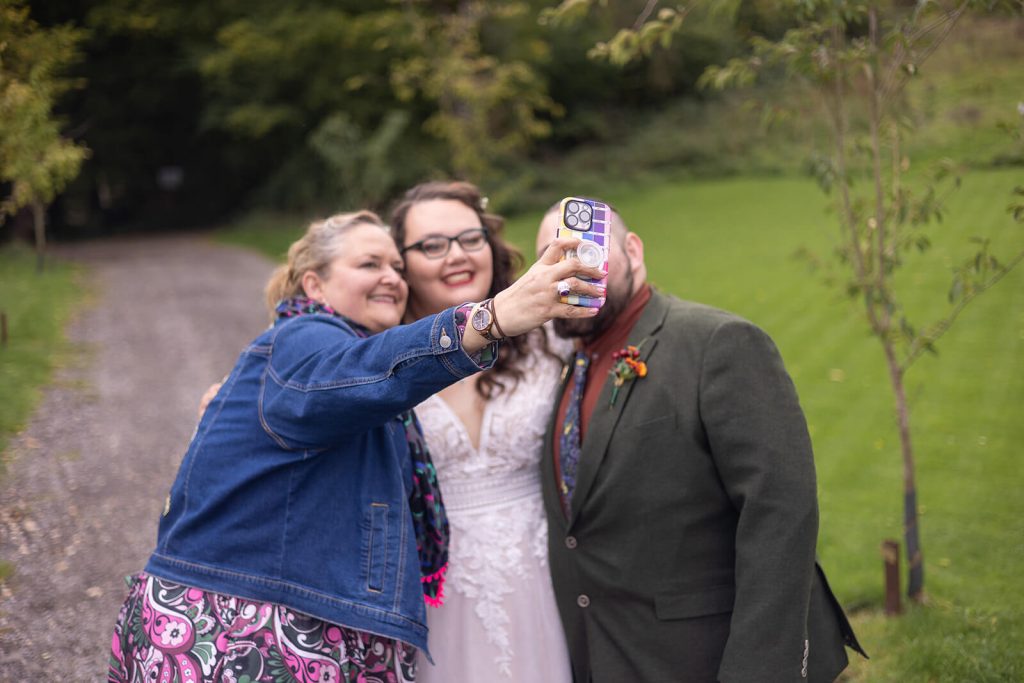 Miranda the Celebrant | Hampshire Ceremonies Three people taking a selfie outdoors.