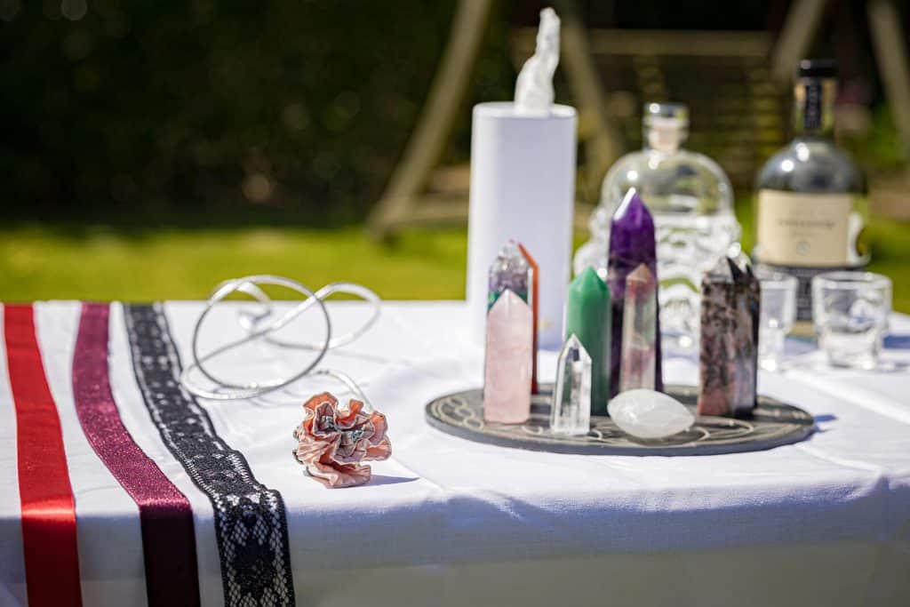 Crystals and decorative items on table. Handfasting ribbons