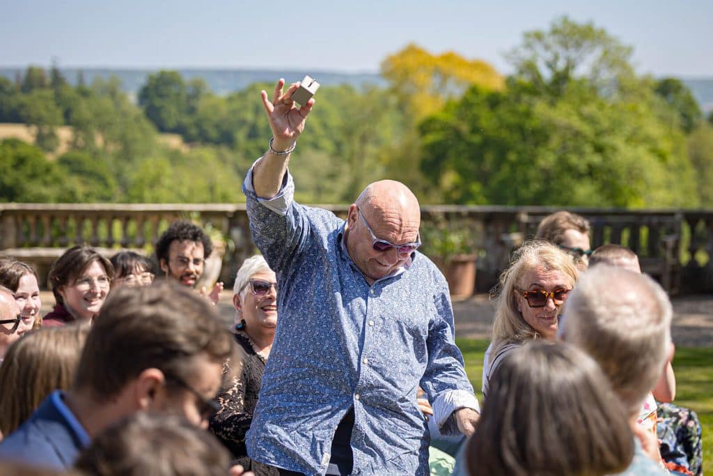 Man celebrating with audience outdoors.