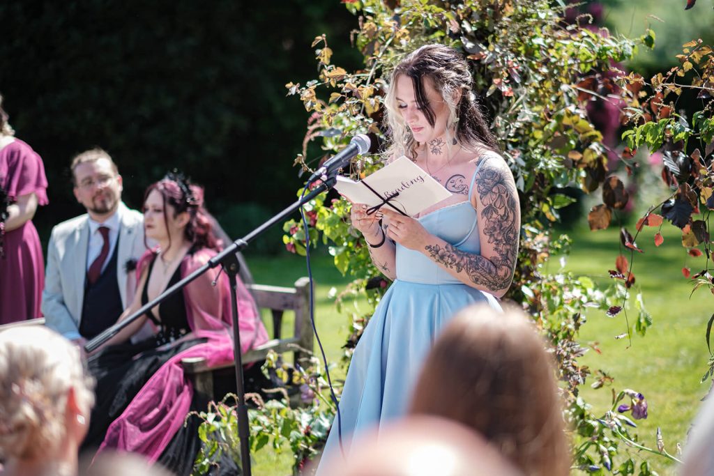 Woman reading at outdoor ceremony