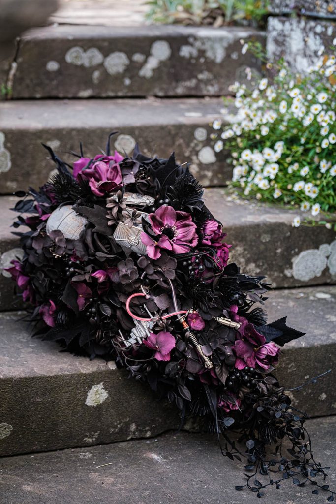 Dark floral arrangement on stone steps