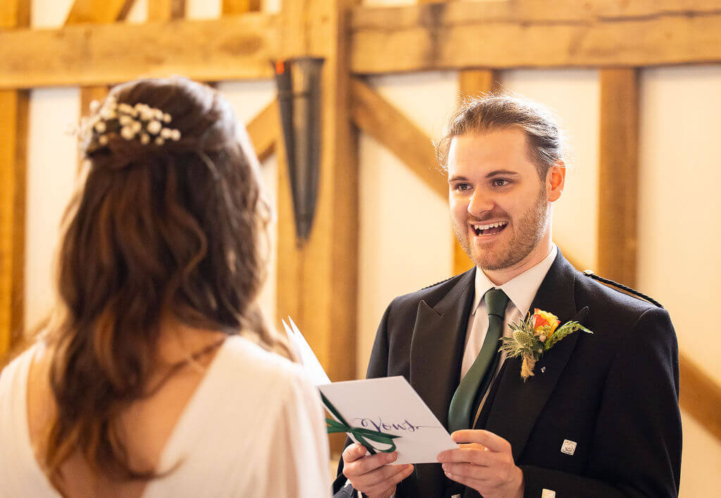 Miranda the Celebrant | Hampshire Ceremonies Couple exchanging vows in rustic setting.