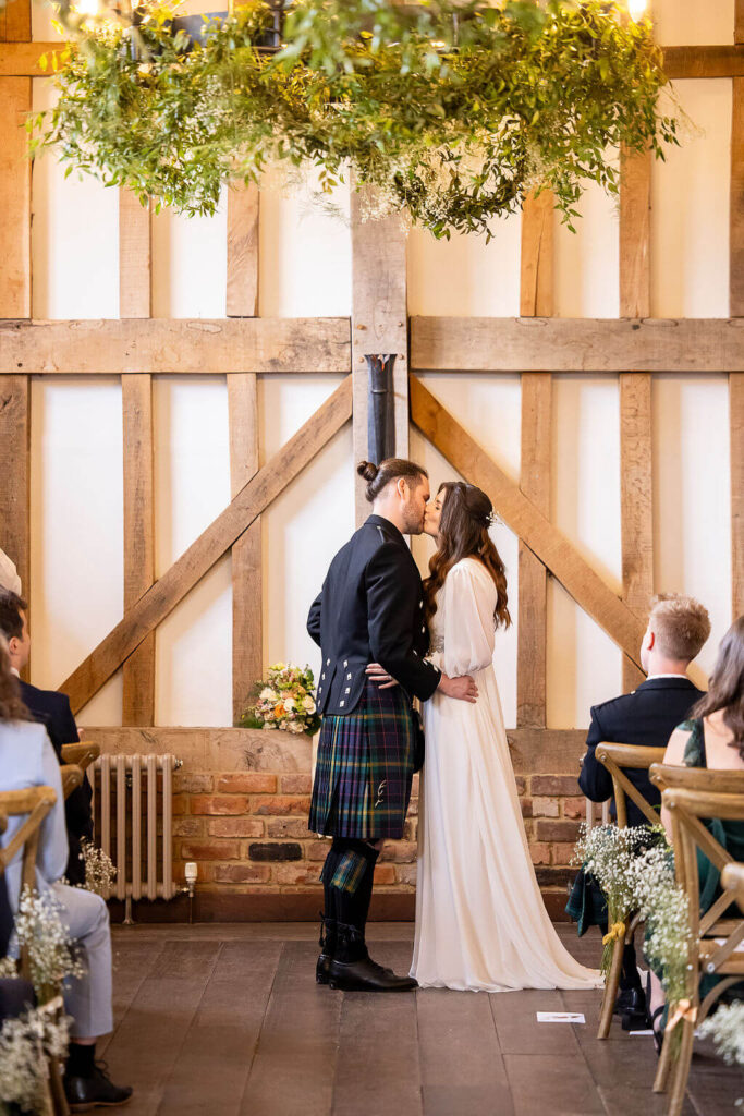 Miranda the Celebrant | Hampshire Ceremonies Couple exchanging vows in rustic setting.