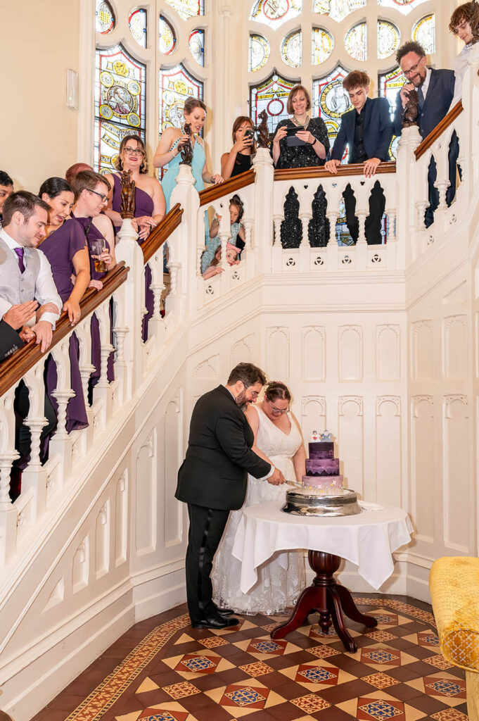 Miranda the Celebrant | Hampshire Ceremonies Wedding couple cutting cake, guests watching