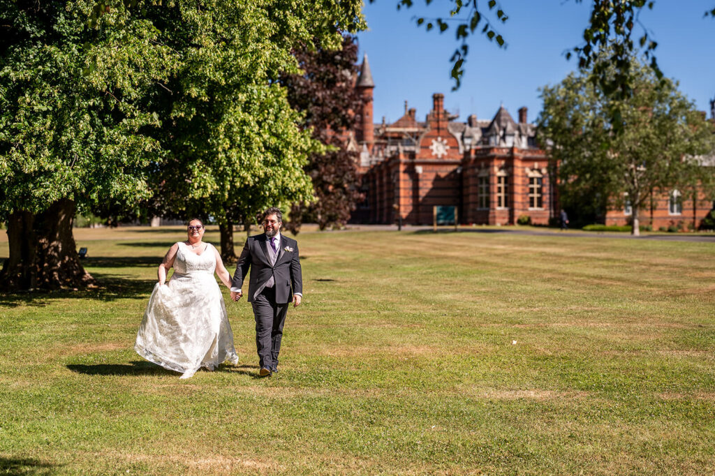 Miranda the Celebrant | Hampshire Ceremonies Couple walking hand in hand outdoors.