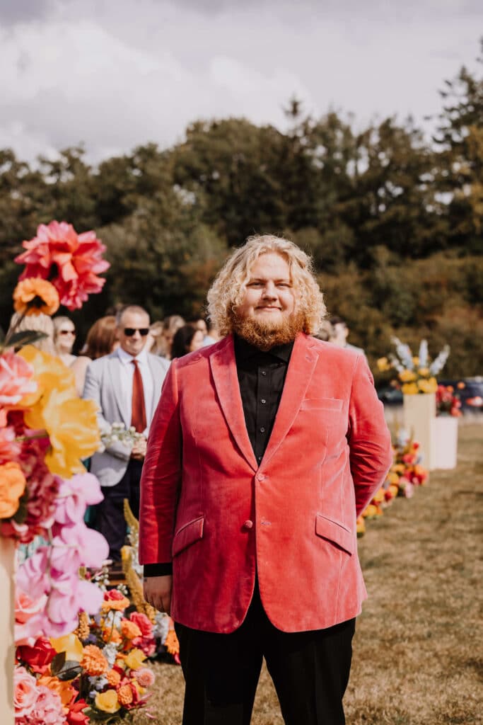 Man in pink suit at wedding