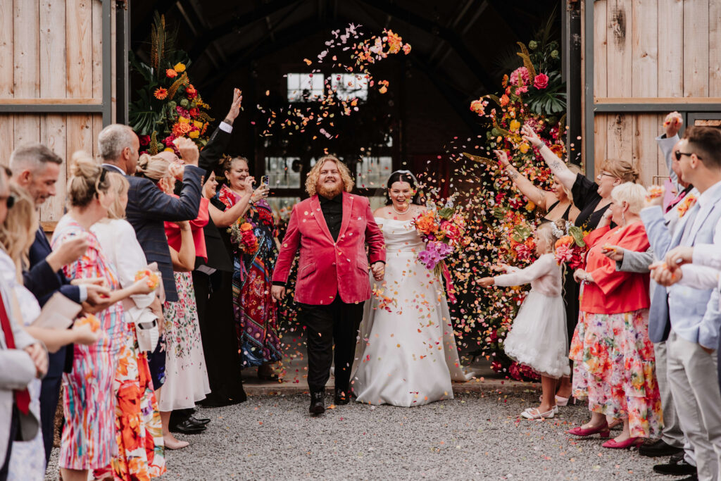 Wedding couple celebrating with confetti