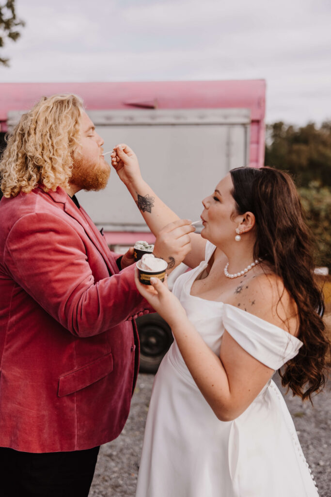 Couple feeding each other dessert.