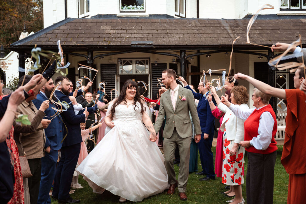 Miranda the Celebrant | Hampshire Ceremonies Wedding celebration with guests and ribbons.