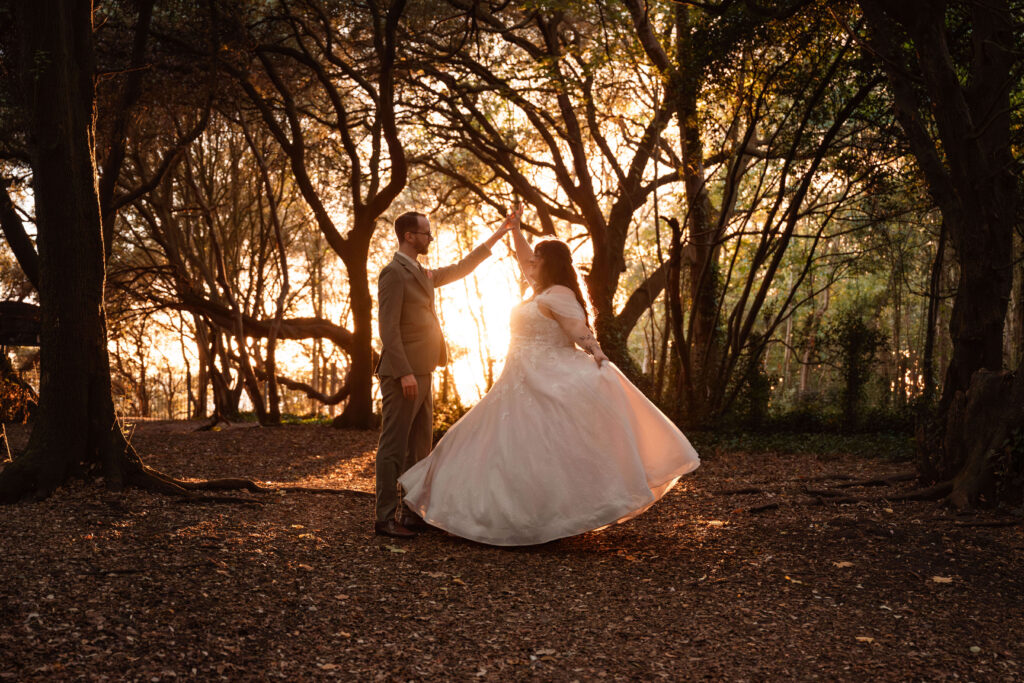 Miranda the Celebrant | Hampshire Ceremonies Couple dancing in a forest at sunset.
