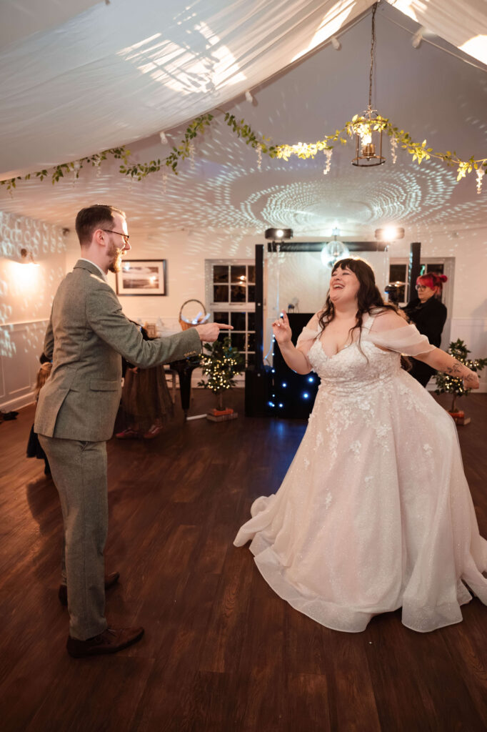 Miranda the Celebrant | Hampshire Ceremonies Couple dancing joyfully at celebration.