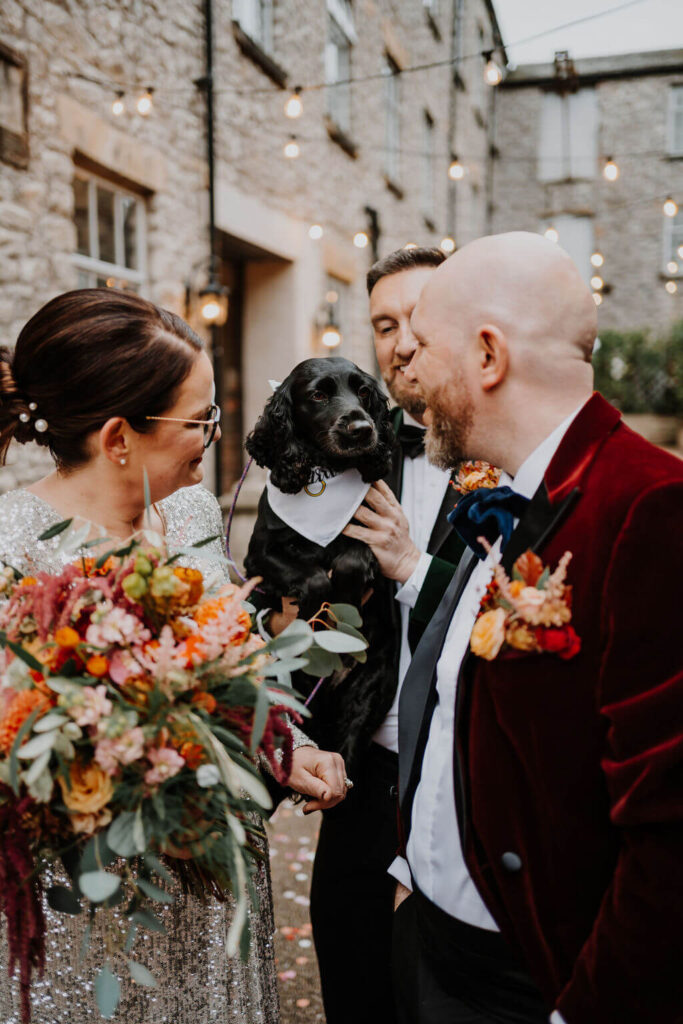 Couple with dog at wedding celebration