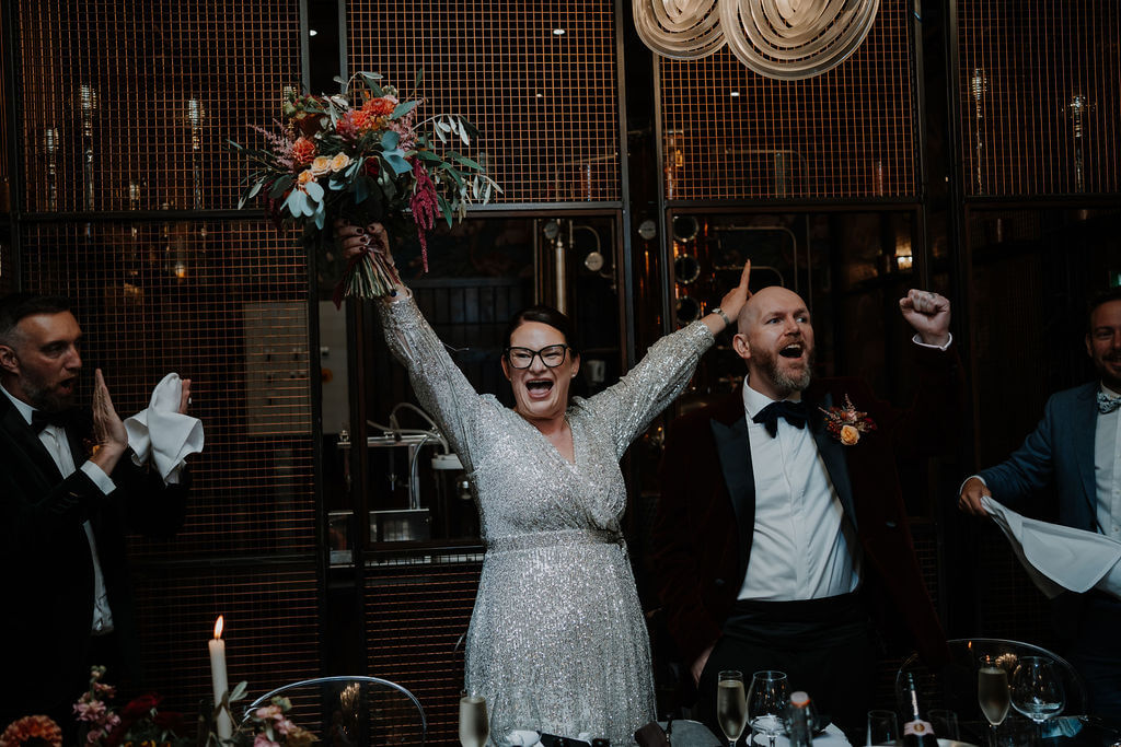 Celebratory wedding reception with joyful guests