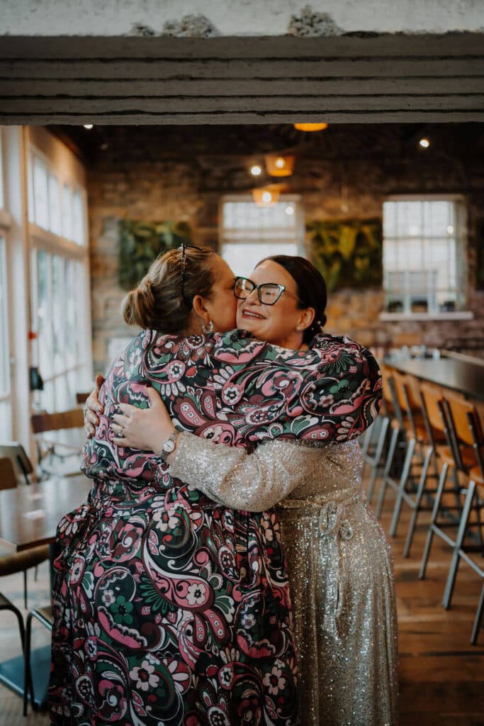 Two women embracing in celebration.