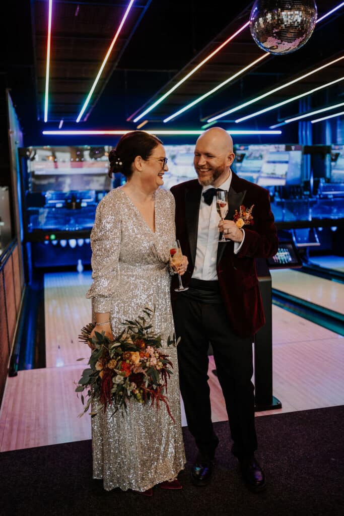Couple celebrating at a bowling alley.
